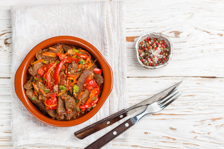 Beef stewed with vegetables-carrots, bell peppers, onions, garlic and spices in ceramic form. A delicious gourmet dinner.  Selective focusの写真素材