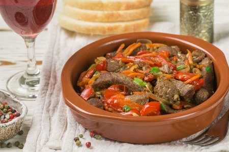 Beef stewed with vegetables-carrots, bell peppers, onions, garlic and spices in ceramic form. A delicious gourmet dinner.  Selective focusの写真素材