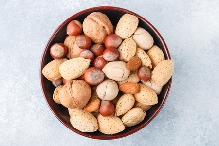Assorted nuts in the peel-almonds, hazelnuts, pecans, walnuts. Gourmet snack. Healthy food. Selective focusの写真素材