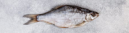 Dried salted fish on grey concrete background.  Traditional Russian appetizer. Selective focus....