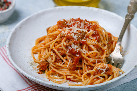 Pasta with tomato sauce, meat, cheese and spices. Lunch or dinner for gourmets. Spaghetti Bolognese. Italian (Mediterranean) cuisine. Selective focusの写真素材