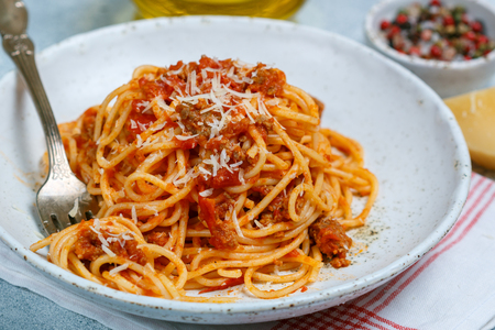 Pasta with tomato sauce, meat, cheese and spices. Lunch or dinner for gourmets. Spaghetti Bolognese. Italian (Mediterranean) cuisine. Selective focusの写真素材