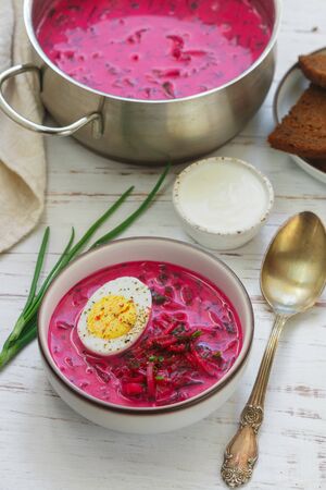 Beetroot soup. Holodnik. Cold summer vegetarian dish of bees, cucumbers, potatoes, eggs, green onions, dill and parsley with kefir or sour cream. Traditional Lithuanian (ukrainian, russian) cuisineの写真素材