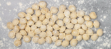 Fresh raw homemade handmade pelmeni (dumplings) with minced meat or fish.