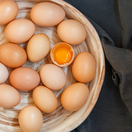 Organic raw brown chicken eggs in a ceramic old dish.