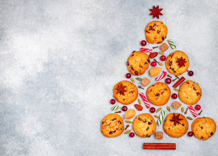 Culinary background of cookies with cranberries, white chocolate, almonds and spices in the form of...