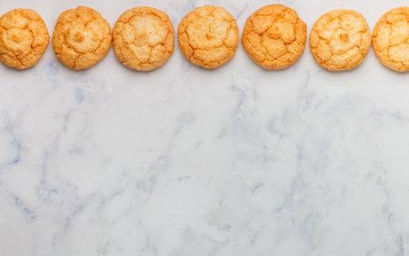 Freshly baked vegan homemade coconut cookies on a light marble table. Healthy food concept. Selective focus, top view, copy spaceの写真素材
