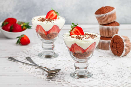 Trifle. Layered Dessert of chocolate sponge cake, whipped cream or ricotta and fresh strawberries in a glass bowl. Delicious gourmet breakfast. Selective Focusの写真素材