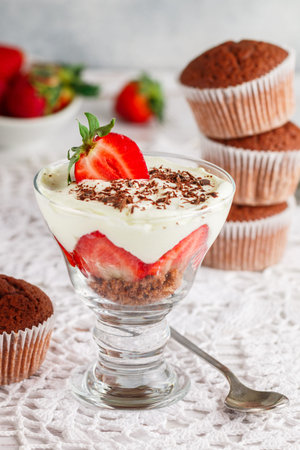 Trifle. Layered Dessert of chocolate sponge cake, whipped cream or ricotta and fresh strawberries in a glass bowl. Delicious gourmet breakfast. Selective Focusの写真素材