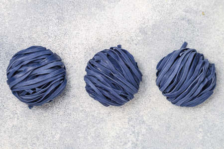 Raw organic wheat blue noodles with anchana flowers. The concept of a healthy and sporty lifestyle. butterfly pea flowers. Thai cuisine. Selective focusの写真素材