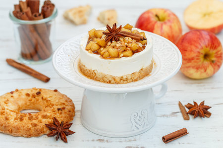 Apple mini vanilla cheesecake. Homemade cake made from shortbread cookies, mascarpone or cream cheese, caramelized apples with cinnamon and star anise. A healthy dessert. breakfast. selective focusの写真素材