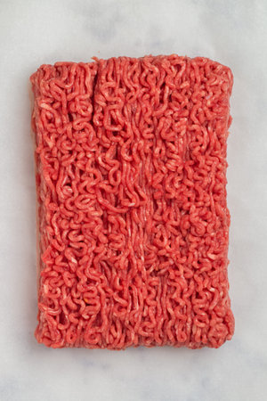 Minced meat close-up. Raw chopped beef. Fresh ingredients for cooking. Culinary background. Selective focus, top viewの写真素材