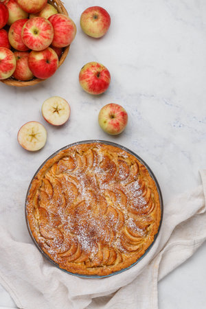 Apple pie. Homemade pie of fresh apples with custard and cinnamon. Delicious autumn pastries. healthy dessert. Marble background. Selective focus, top view and copy spaceの写真素材