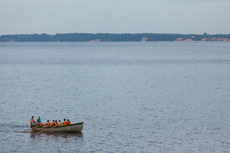 Rowers in lifejackets on a boat sail along the Gorky water reservoir on the Volga Riverのeditorial素材