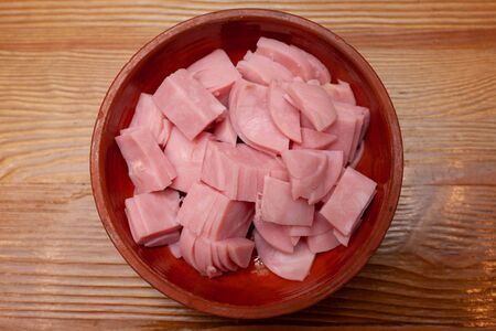 Sliced sausage in a plate on the tableの写真素材