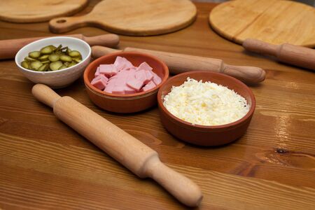 Pizza ingredients and rolling pins on the tableの写真素材
