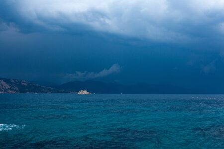 Blue sea and clouds in a blue stormy skyの写真素材