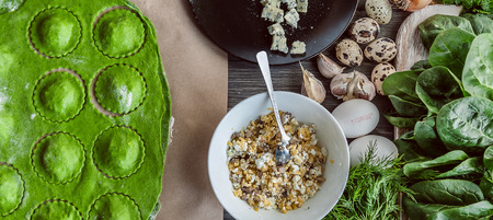 chef step by step, preparing a green ravioli with the addition of spinach dough, stuffed with ricotta and porcini mushrooms.の写真素材
