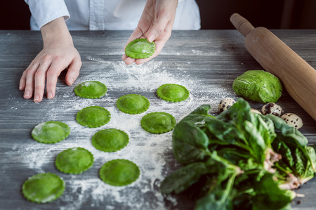 chef step by step, preparing a green ravioli with the addition of spinach dough, stuffed with ricotta and porcini mushrooms.の写真素材