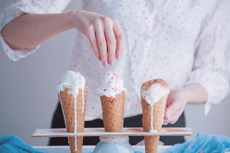 Three ice cream cones on a wooden background