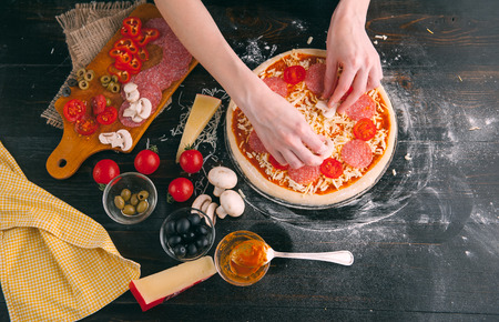 Raw pizza ingredients on wooden tableの写真素材