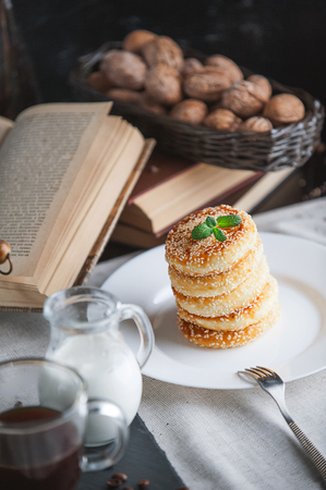 breakfast. coffee with cream and cheese cakes with sesameの写真素材