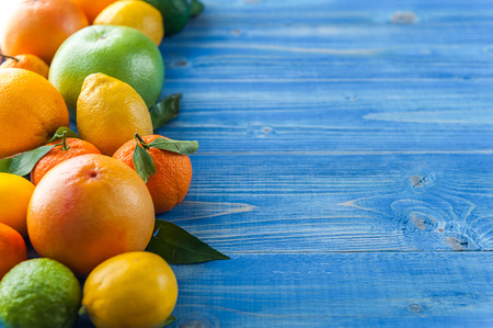 citrus fruits on a wooden blue backgroundの写真素材