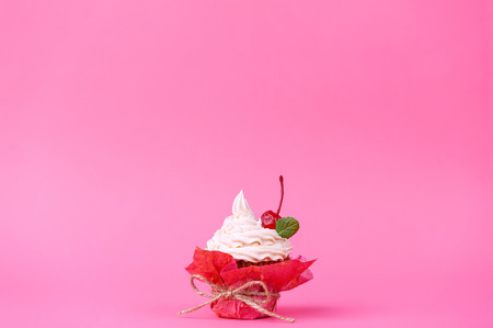 muffin with cream on a pink background.の写真素材