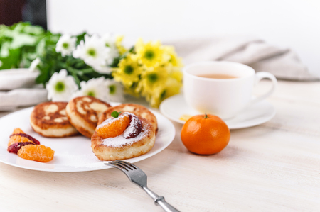 cheese pancake with citrus fruits and jam on a wooden table with tea. Breakfast conceptの写真素材