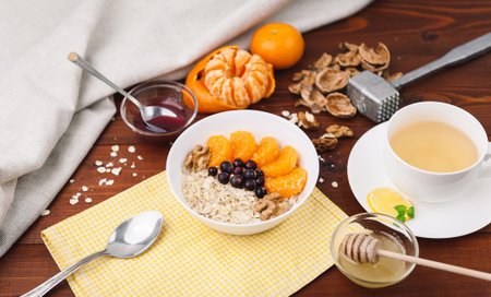 Oatmeal with fruit and berries on a wooden background.の写真素材