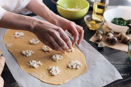 Step by step the chef prepares ravioli with ricotta cheese, yolks quail eggs and spinach with spices. The chef prepares the filling on the doughの写真素材