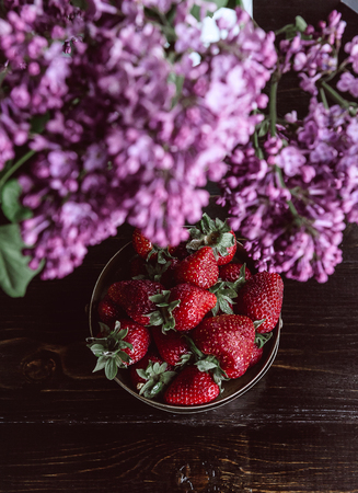 Ripe organic strawberry on a wooden background in a rustic styleの写真素材