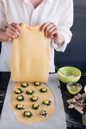 Step by step the chef prepares ravioli with ricotta cheese, yolks quail eggs and spinach with...