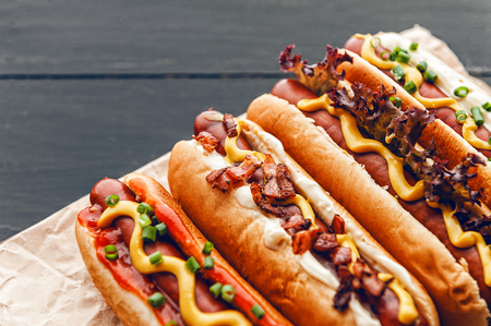 Barbecue Grilled Hot Dogs with  yellow American mustard, On a dark wooden backgroundの写真素材