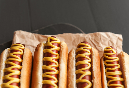 Barbecue Grilled Hot Dogs with  yellow American mustard, On a dark wooden backgroundの写真素材