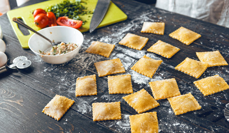Woman chef cooks step by step the traditional ravioliの写真素材