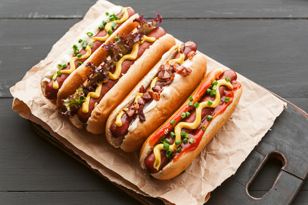 Barbecue Grilled Hot Dogs with  yellow American mustard, On a dark wooden backgroundの写真素材