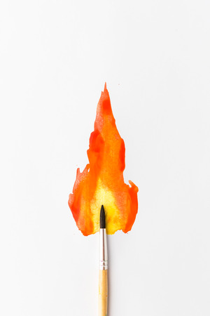 Artstic brush sleep white sheet of paper with a picture of fire artの写真素材