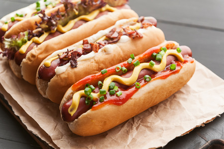 Barbecue Grilled Hot Dogs with  yellow American mustard, On a dark wooden backgroundの写真素材