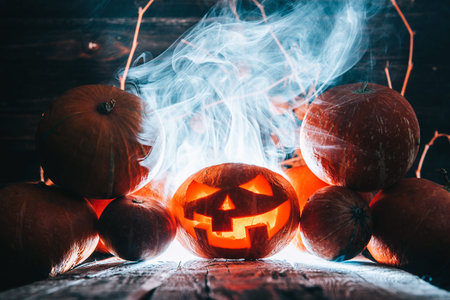 Pumpkin to celebrate Halloween on a wooden background