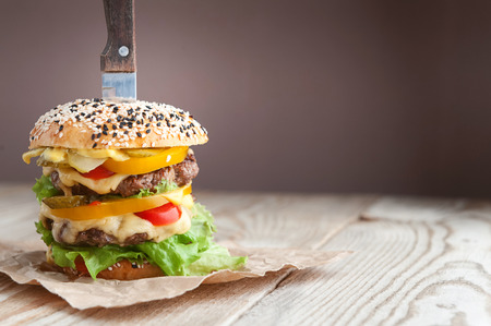 delicious juicy home burger. roll, bagel, with a juicy cutlet from beef, sauces cheese fresh lettuce leavesの写真素材