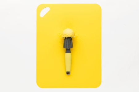 press for lemon with lemon on a yellow background