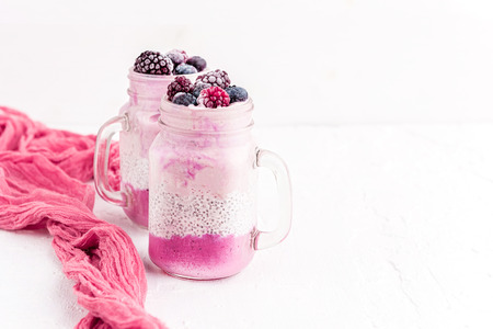 chia with yoghurt, frozen bananas and wild berries, on a white backgroundの写真素材