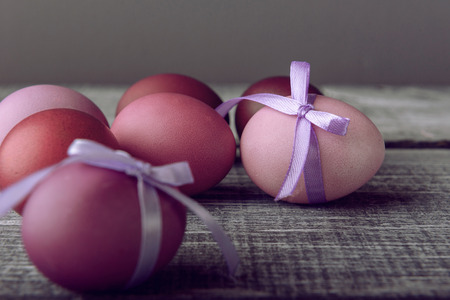 Easter eggs in fashionable colors on a gray wooden backgroundの写真素材