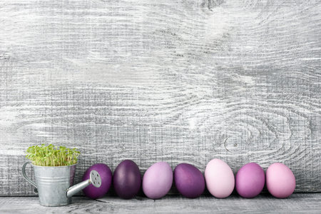 Easter eggs in fashionable colors on a gray wooden background
