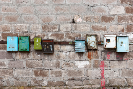 old mailboxes on an old dirty wallの写真素材
