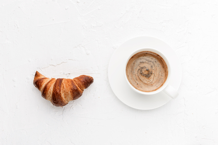 croissants with a cup of coffee on a white backgroundの写真素材