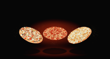 Three different pizza fly in the air against a dark background. menu and selection conceptの写真素材
