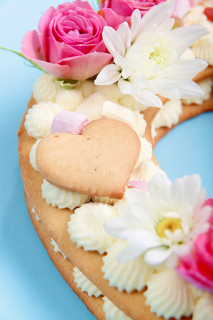 Valentine's Day heart-shaped cake with flowers as decoration. The concept of a gift to a loved one on a holiday.の写真素材