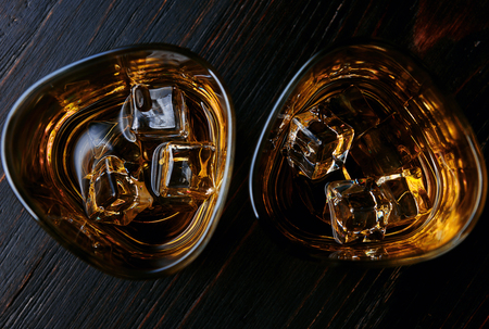 whiskey with ice in modern glassesの写真素材